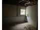 Basement with a window, partial wall covering and concrete floor at 7235 Thornhill Ne Ln, Atlanta, GA 30328