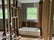 Unfinished bathroom with tub and window at 7235 Thornhill Ne Ln, Atlanta, GA 30328