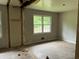 Bedroom with exposed studs, offering potential for renovation and personalization to suit individual tastes at 7235 Thornhill Ne Ln, Atlanta, GA 30328