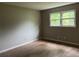 Empty bedroom featuring hardwood floors and a double window at 7235 Thornhill Ne Ln, Atlanta, GA 30328