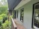 The side of the home features a covered porch, with damaged windows at 7235 Thornhill Ne Ln, Atlanta, GA 30328