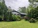 Charming single-story home surrounded by lush greenery and mature trees, creating a private and serene setting at 7235 Thornhill Ne Ln, Atlanta, GA 30328