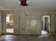 Spacious garage with paneled walls and potential, awaiting transformation into a functional area at 7235 Thornhill Ne Ln, Atlanta, GA 30328