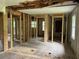 Open living area with exposed framing, awaiting a visionary touch to transform into a welcoming space at 7235 Thornhill Ne Ln, Atlanta, GA 30328