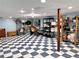 Spacious basement with checkered floors, ample storage, and functional shelving for organization at 7326 Leland Ln, Jonesboro, GA 30236