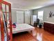 Cozy bedroom with hardwood floors, and natural light creating a warm and inviting atmosphere at 7326 Leland Ln, Jonesboro, GA 30236