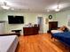 Large bedroom with hardwood floors, a large TV, and plenty of space for multiple beds and seating at 7326 Leland Ln, Jonesboro, GA 30236