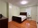 Comfortable bedroom with hardwood floors, a sleigh bed, and bright walls for a calming atmosphere at 7326 Leland Ln, Jonesboro, GA 30236