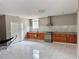 Modern kitchen with stainless steel appliances, granite countertops, and white marble-look tile flooring at 7326 Leland Ln, Jonesboro, GA 30236