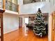 Inviting living room with a Christmas tree and a dining area, featuring hardwood floors at 7326 Leland Ln, Jonesboro, GA 30236