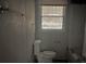 A bathroom features a window for natural light offering a simple, functional space ready for renovation and updates at 971 Canyon Sw Trl, Marietta, GA 30060