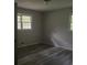 Bedroom boasts gray floors, light walls, and window, creating a serene atmosphere with ample natural light at 971 Canyon Sw Trl, Marietta, GA 30060