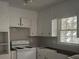 Bright kitchen featuring white cabinets and appliances offering a clean canvas ready for your personal touches and customization at 971 Canyon Sw Trl, Marietta, GA 30060