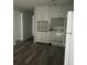 Bright kitchen featuring sleek gray floors, white cabinets and appliances, providing a clean and modern space for cooking and storage at 971 Canyon Sw Trl, Marietta, GA 30060