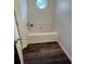 Bright bathroom with a tub and modern wood-look flooring at 1263 Brookstone Rd, Atlanta, GA 30349