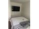 Clean bedroom with a queen size bed, carpet, and a mounted TV at 1263 Brookstone Rd, Atlanta, GA 30349