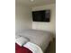 Clean bedroom with a queen size bed, carpet, and a mounted TV at 1263 Brookstone Rd, Atlanta, GA 30349