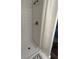 Bright shower area with white tiled walls, a walk-in shower, and textured flooring at 1263 Brookstone Rd, Atlanta, GA 30349