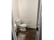 Small bathroom with toilet, wood-look floors, and a sink on the side at 1263 Brookstone Rd, Atlanta, GA 30349