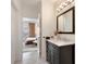 Bathroom with a dark vanity, marble countertop, and view into the bedroom at 1850 Cotillion Dr # 2304, Dunwoody, GA 30338