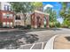 Exterior shot of a brick condo building with covered arched entryway at 1850 Cotillion Dr # 2304, Dunwoody, GA 30338