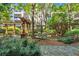 Serene courtyard featuring lush greenery and a covered pergola seating area at 1850 Cotillion Dr # 2304, Dunwoody, GA 30338
