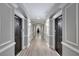 Hallway with gray walls, white trim, and dark doors on either side at 1850 Cotillion Dr # 2304, Dunwoody, GA 30338