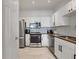 Modern kitchen featuring stainless steel appliances, granite countertops, and white cabinets at 1850 Cotillion Dr # 2304, Dunwoody, GA 30338