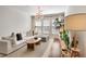 Spacious living room with a large sofa, decorative chandelier, and entertainment center at 1850 Cotillion Dr # 2304, Dunwoody, GA 30338