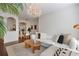 Bright living room features a white sofa and hardwood floors, open to dining at 1850 Cotillion Dr # 2304, Dunwoody, GA 30338