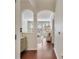 Hallway leading to the bright living room with white sofas and hardwood floors at 1850 Cotillion Dr # 2304, Dunwoody, GA 30338
