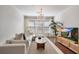 Bright living room features a chandelier, white couch, and hardwood floors at 1850 Cotillion Dr # 2304, Dunwoody, GA 30338
