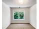 Bedroom with carpet and large window overlooking backyard greenery at 2031 Austin Park Cir, Decatur, GA 30032