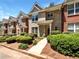 Charming brick townhome featuring well-maintained landscaping and a sidewalk to the door at 2031 Austin Park Cir, Decatur, GA 30032