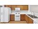 Bright kitchen with white appliances, light wood cabinets, and laminate countertops at 2031 Austin Park Cir, Decatur, GA 30032
