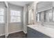 Bathroom featuring a vanity, marble countertop, ample storage, and a large mirror at 2146 Chevy Chase Ln, Decatur, GA 30032
