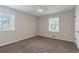Bright bedroom featuring neutral carpet, a ceiling fan, and two large windows for natural light at 2146 Chevy Chase Ln, Decatur, GA 30032