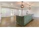 Kitchen island with seating, granite countertops, stainless steel appliances, and modern lighting at 2146 Chevy Chase Ln, Decatur, GA 30032