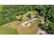 Beautiful property with a home, barn, and outbuildings set amongst lush green fields and trees at 220 Mountain Creek Rd, Bowdon, GA 30108