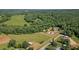 Sprawling rural property features a charming home, lush green fields, and dense woodlands at 220 Mountain Creek Rd, Bowdon, GA 30108