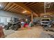 View of the open basement with an ATV, a parked car, and an open space with lots of storage at 220 Mountain Creek Rd, Bowdon, GA 30108