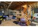 View of the open basement with an unfinished staircase and lots of storage at 220 Mountain Creek Rd, Bowdon, GA 30108