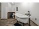 Elegant bathroom featuring a clawfoot tub with a modern faucet and wood-look tile flooring at 220 Mountain Creek Rd, Bowdon, GA 30108