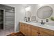 Modern bathroom with double sinks, marble countertops, and stylish mirrors, featuring shiplap wall at 220 Mountain Creek Rd, Bowdon, GA 30108