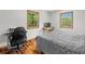 Comfortable bedroom with hardwood floors, a simple bed, and natural light from two windows, desk at 220 Mountain Creek Rd, Bowdon, GA 30108