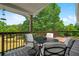View of the deck area including an outdoor table with an umbrella and chairs with cushions at 220 Mountain Creek Rd, Bowdon, GA 30108