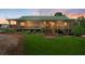 Charming home featuring a green roof, spacious porch with wooden railings, and lovely landscaped front yard at 220 Mountain Creek Rd, Bowdon, GA 30108
