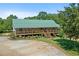 Charming single-story home featuring a full-length porch, set amidst lush greenery, creating a serene retreat at 220 Mountain Creek Rd, Bowdon, GA 30108