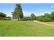 Charming home with a green roof, inviting front porch, and spacious lawn under a clear sky at 220 Mountain Creek Rd, Bowdon, GA 30108