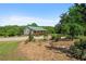Beautiful home with a green roof and inviting front porch surrounded by mulch beds and landscaping at 220 Mountain Creek Rd, Bowdon, GA 30108